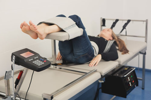 A woman on a chiropractic bed